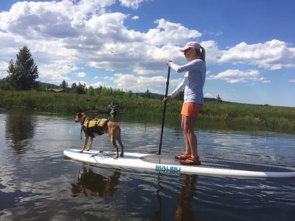 Cathy Eason Paddle Boarding with Her Dog